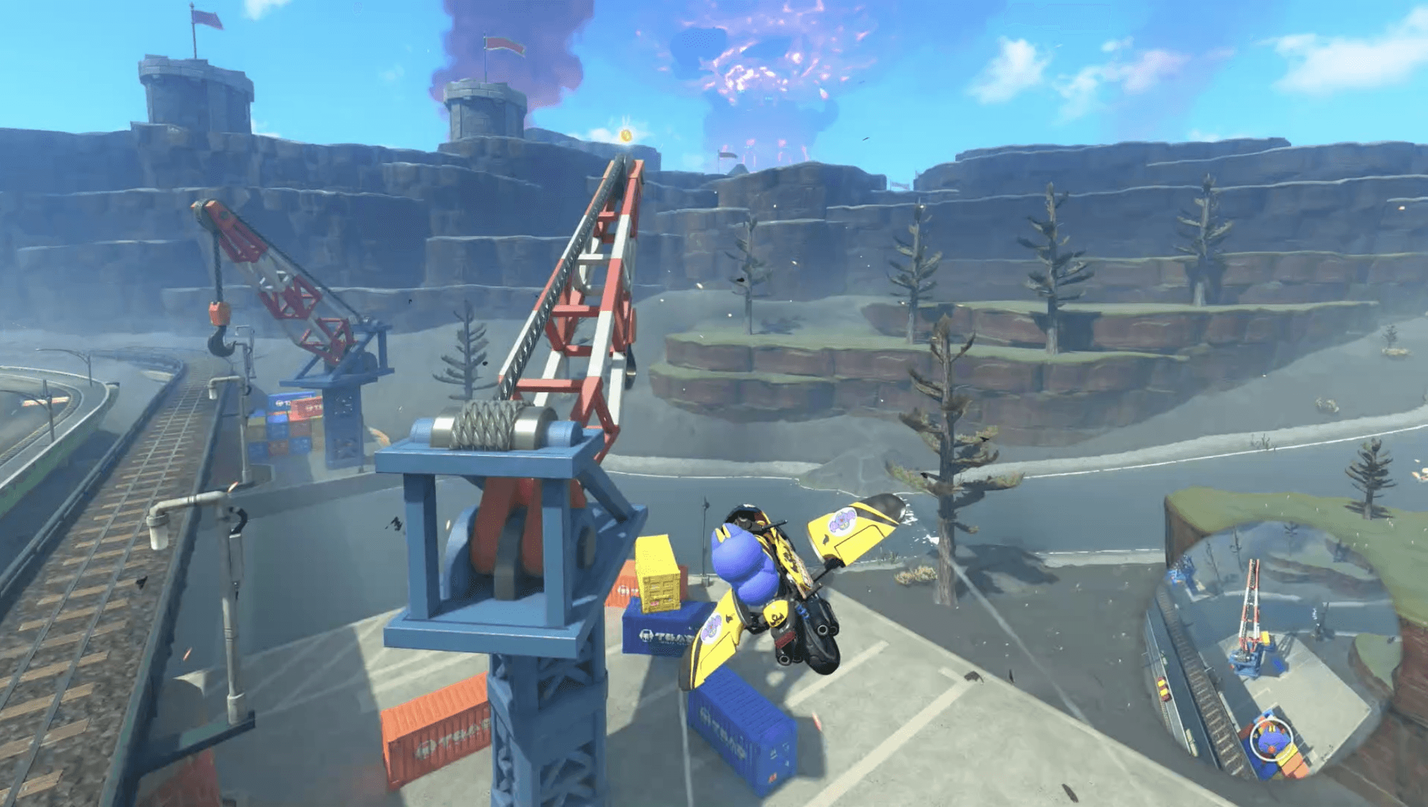 A still from a video I captured in Mario Kart World after collecting the crane Peach Medallion. The still shows my flight towards the crane, far enough back to allow much of the crane, the medallion, and the surrounding area to all appear in frame.